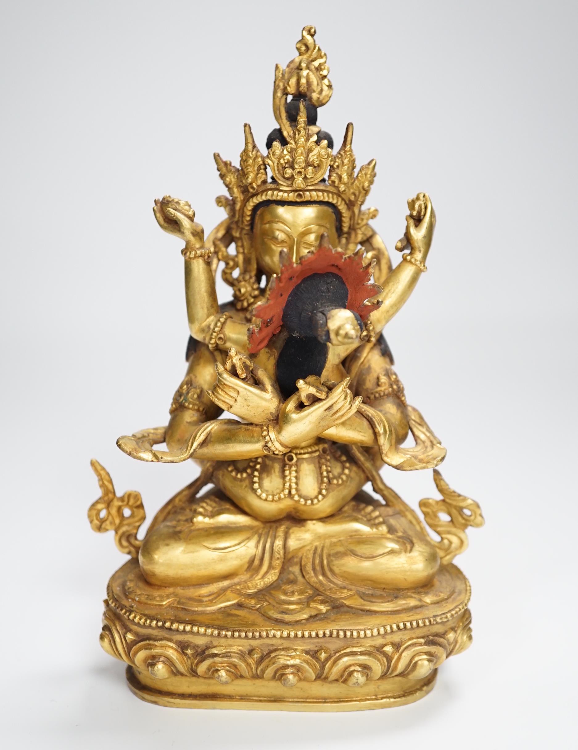 A Sino Tibetan gilt bronze group of a deity with consort, 22.5cm high